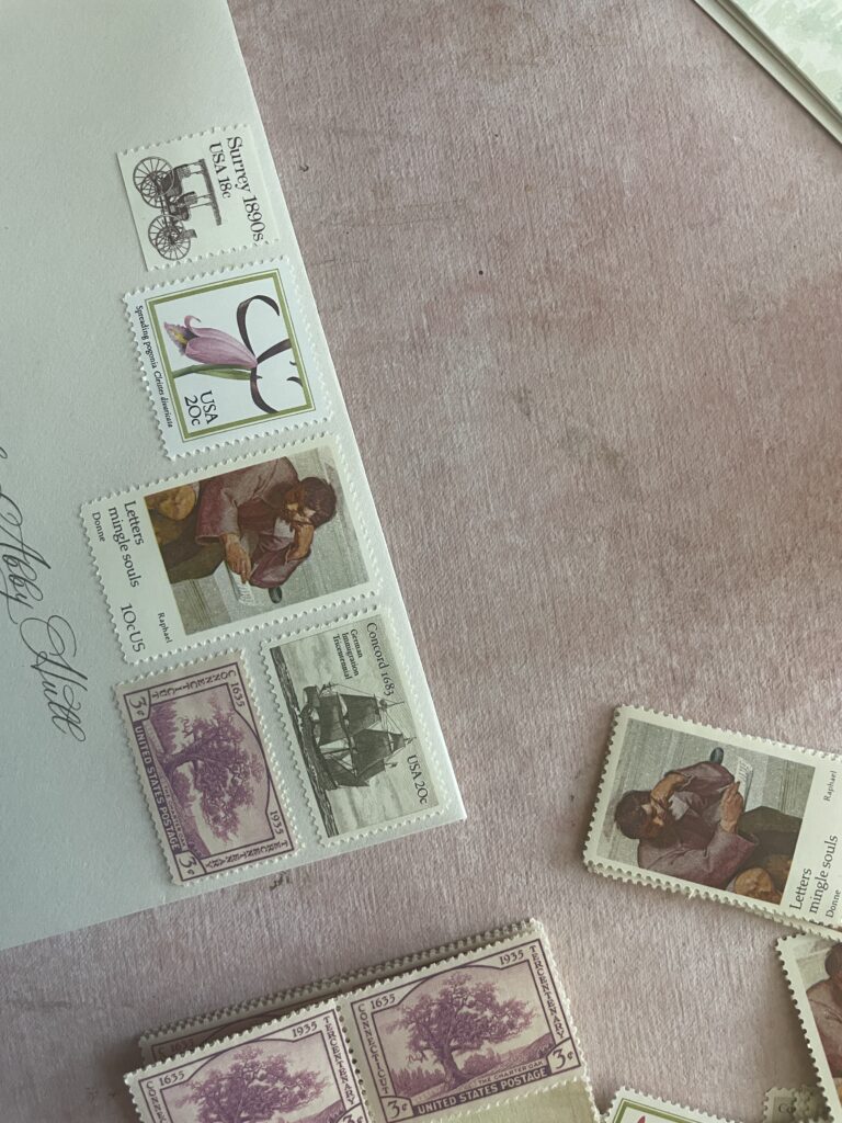 mix of pink vintage stamps on an envelope on a pink background