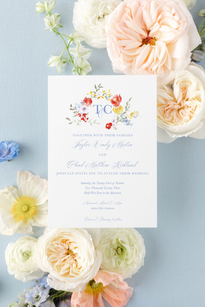 watercolor floral wedding invitation on a blue background