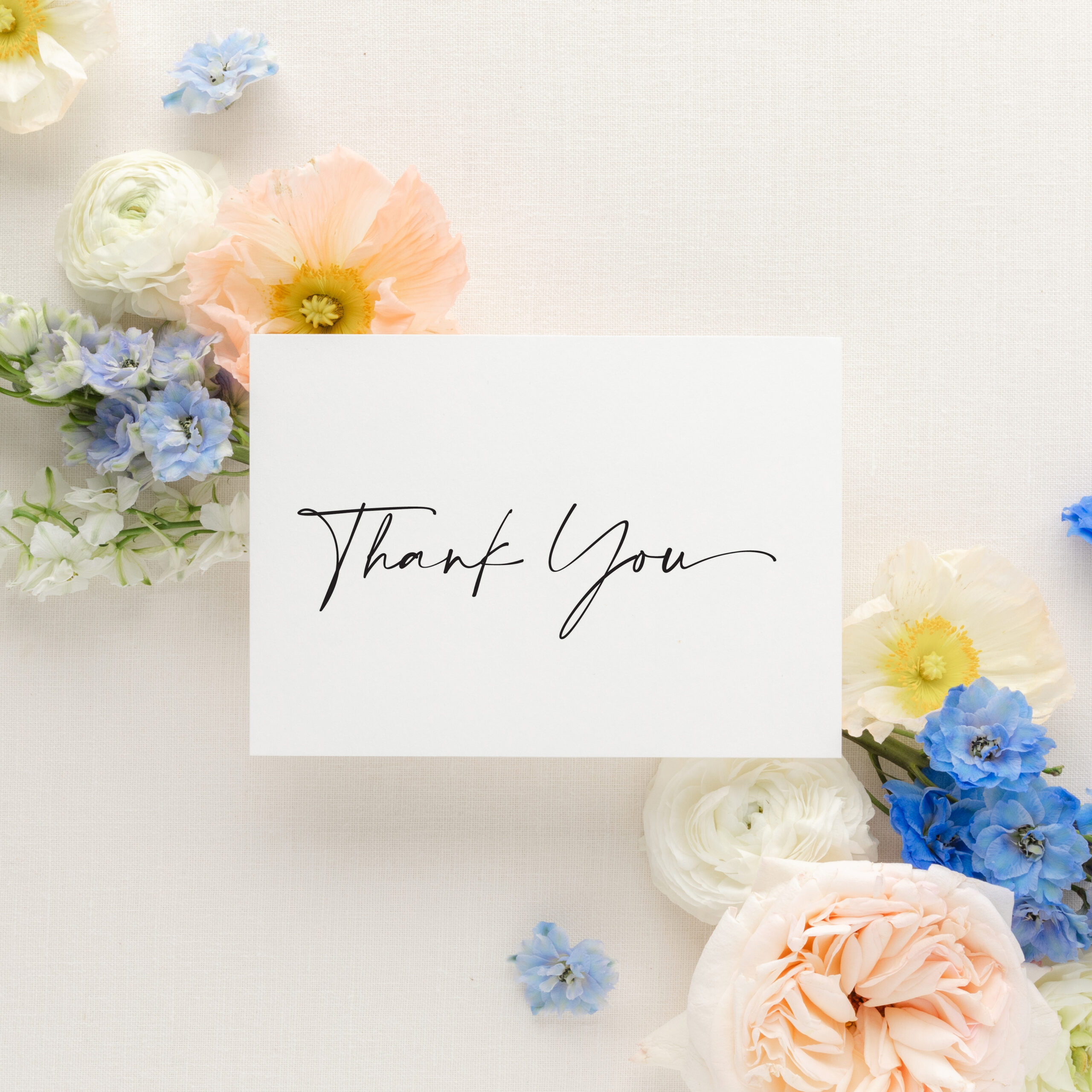 black and white calligraphy thank you card on white background with colorful flowers