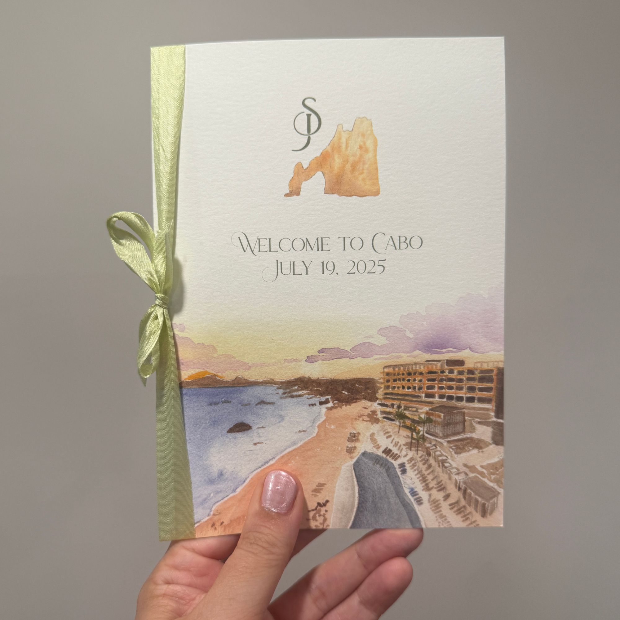 watercolor wedding itinerary that says "welcome to cabo"